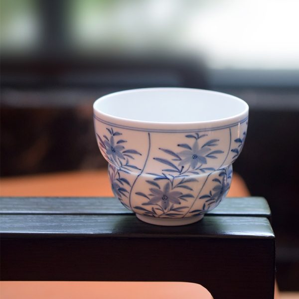 Handcrafted ceramic cup with underglaze blue pattern and thin body
