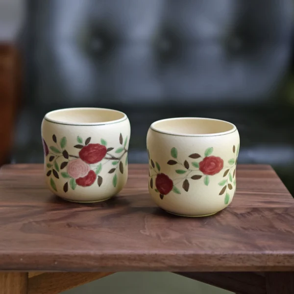 Two ceramic coffee mugs with front and back designs, gourd-shaped body for a comfortable grip.