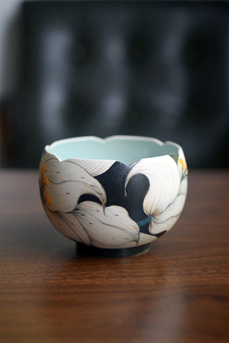 Floral-rim ceramic Lily Cup and Saucer with hand-painted lily design, perfect for camping coffee moments