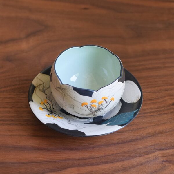 Handmade ceramic Lily Cup and Saucer with floral rim, perfect for enjoying cappuccino at home