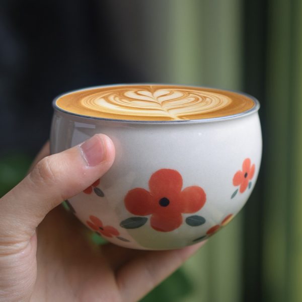 Hand-painted ceramic cup with custom red floral design, handmade and unique, perfect for daily use