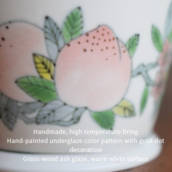Hand-painted peach ceramic coffee cup with under-glaze design, crafted with ash glaze and warm white surface