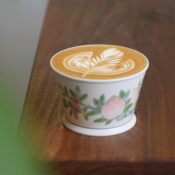 Hand-painted ceramic peach coffee cup with under-glaze vintage Chinese design, perfect for lattes and adding elegance to your coffee moments