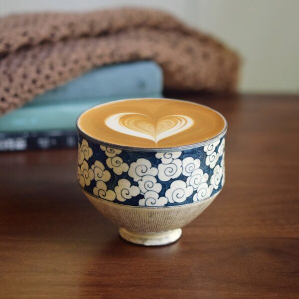 Vintage ceramic cup with hand-painted cloud pattern and heart-shaped latte art, classic design, perfect for daily business coffee use