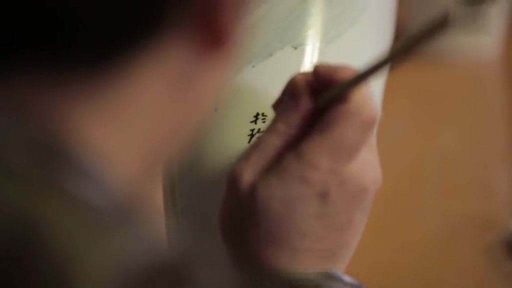 Jingdezhen porcelain firing process The process of adding text, such as dates, signatures, or decorative phrases, onto ceramic pieces.