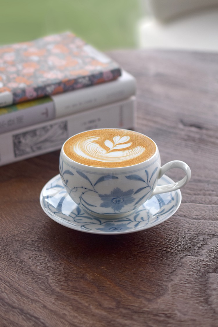 Handcrafted blue and white porcelain coffee cup ideal for reading time, combining traditional Chinese style with quiet elegance