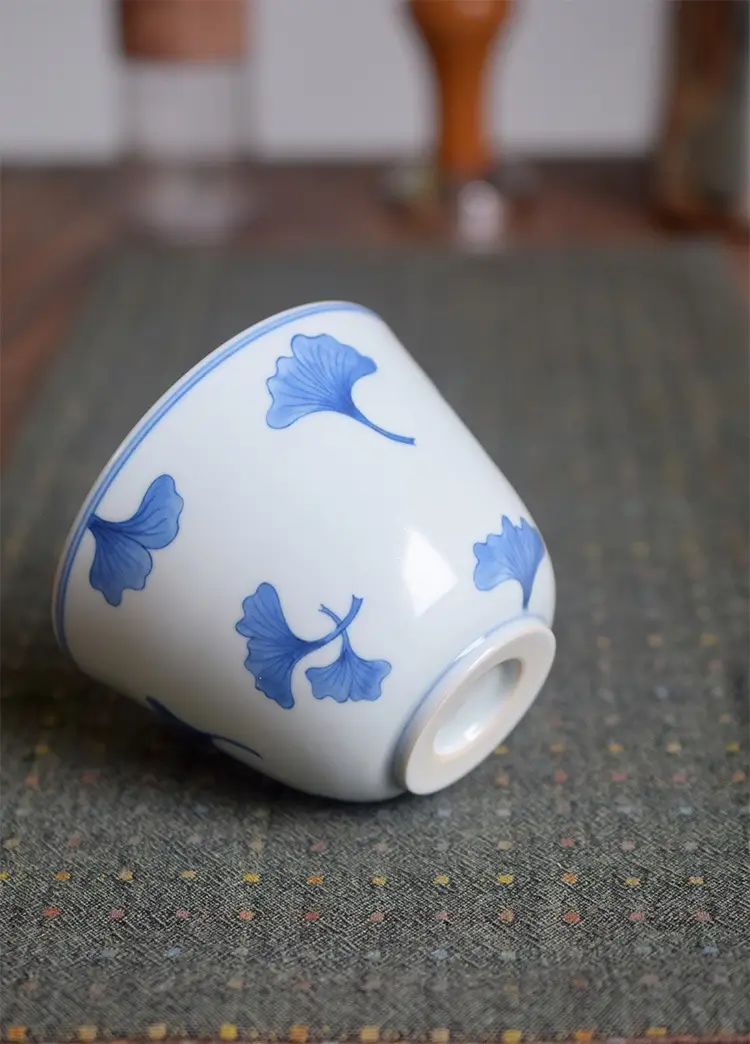 Hand-painted blue and white porcelain cup with footed base, ideal gift choice for beloved family members