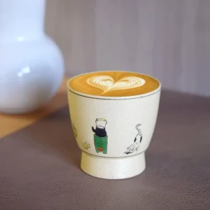 Ceramic coffee mug features a hand-painted lifestyle scene in vintage cute style for practical everyday drinkware