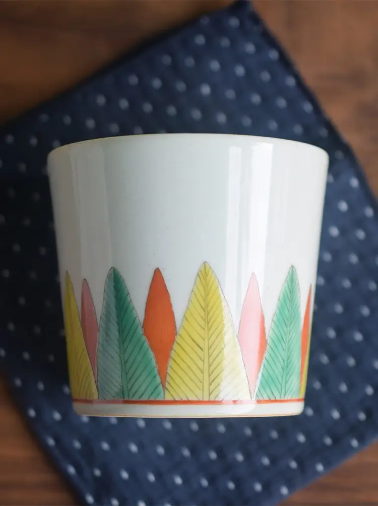 Chinese handcrafted ceramic coffee mug features hand-painted banana leaves for a truly unique custom experience.