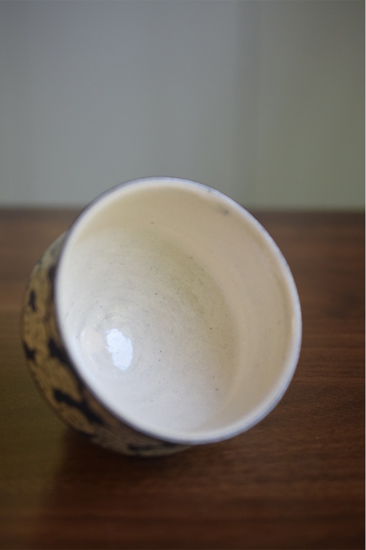 Interior glaze detail of hand-painted cloud ceramic coffee cup with smooth underglaze surface and fine finish