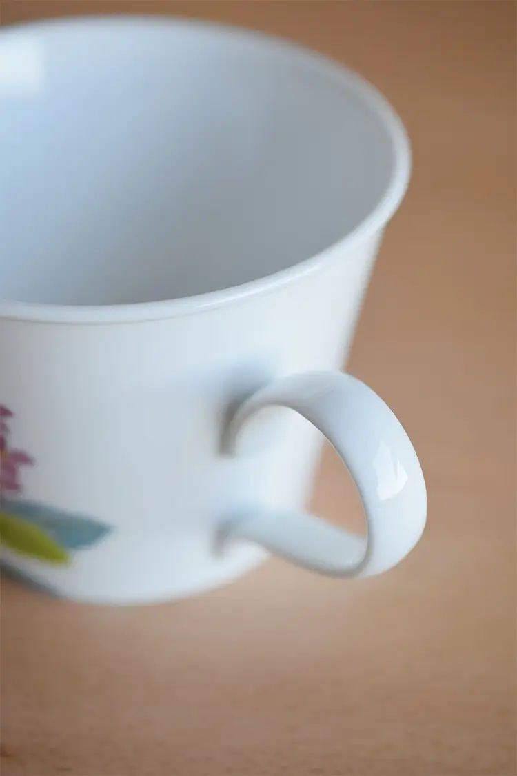 Coffee cup with handle for enhanced drinking experience.