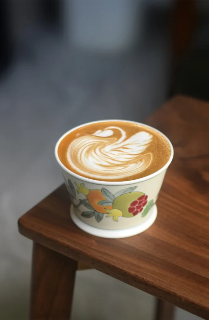 Custom business ceramic coffee cup with hand-painted Chinese pomegranate design symbolizes good fortune.