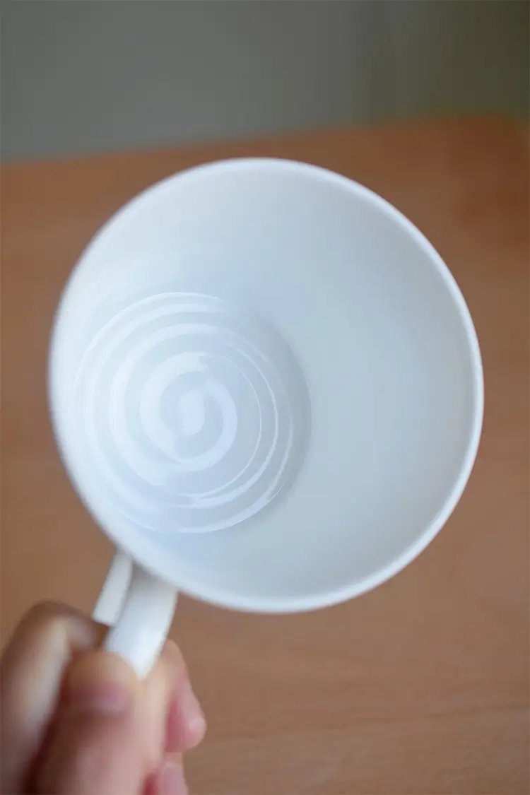 Custom ceramic cup with smooth glazed interior and handmade traces, ideal for craft lovers.