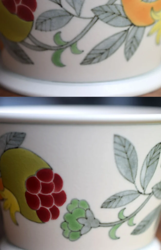 Custom coffee cup features hand-painted pomegranate details and matte glaze for refined daily use.