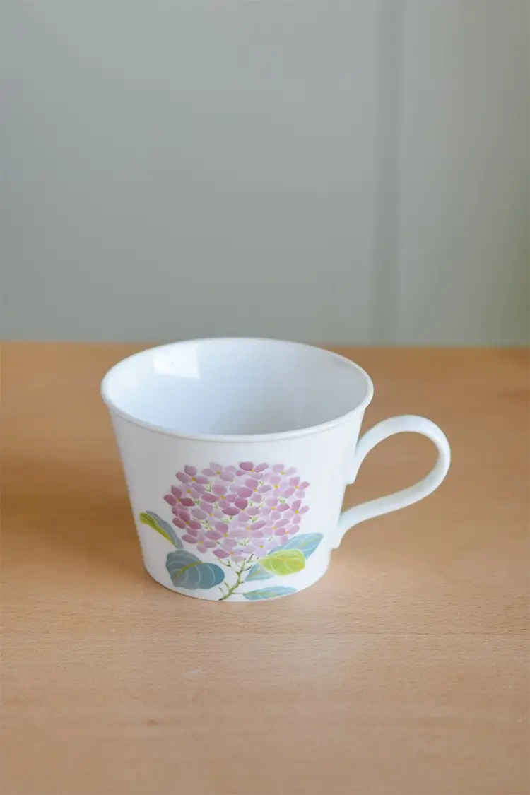 Custom ceramic cup with hydrangea design, perfect for serving tea or coffee.