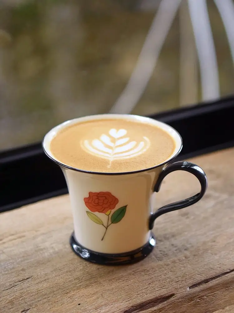 Custom rose-themed coffee mug features underglaze art, making it a perfect holiday gift for her.