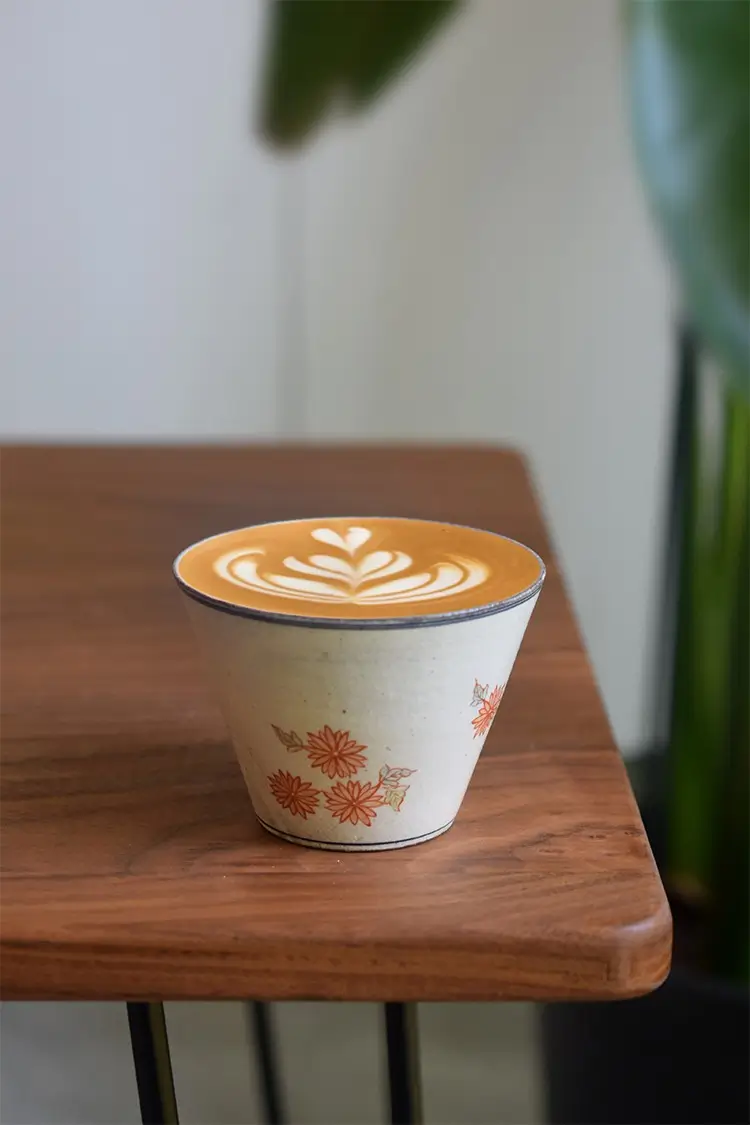 Hand-painted daisy ceramic cup enhances vintage interiors with Japanese charm, serving as both decor and a functional accent.