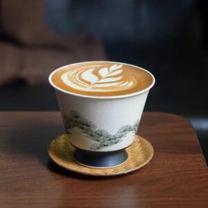 Hand-painted ceramic cup with pine tree design, perfect for lattes or tea, showcasing traditional craftsmanship.