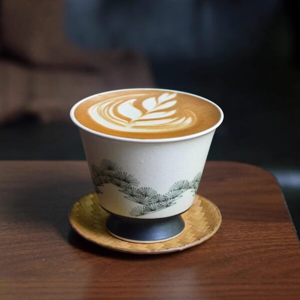 Hand-painted ceramic cup with pine tree design, perfect for lattes or tea, showcasing traditional craftsmanship.