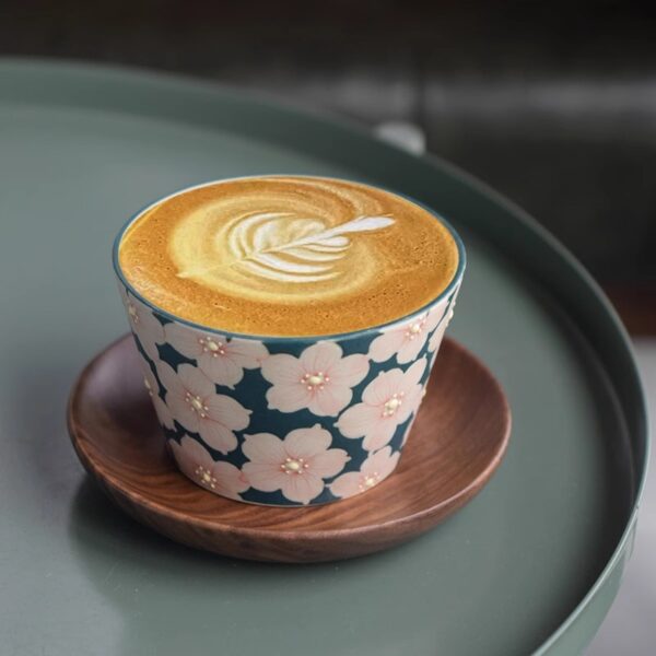 Latte served in a handmade ceramic mug, beautifully set on a desk for a relaxing coffee break