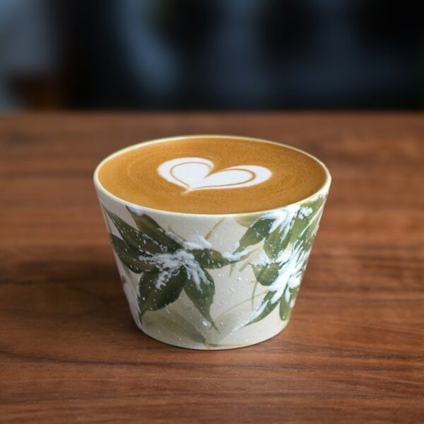 Handmade ceramic coffee cup with hand-painted bamboo leaf design and blue-and-white underglaze craftsmanship