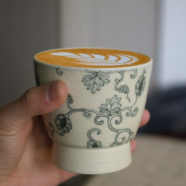 Handmade ceramic coffee cup filled with latte, personally brewed as a gift for mom.