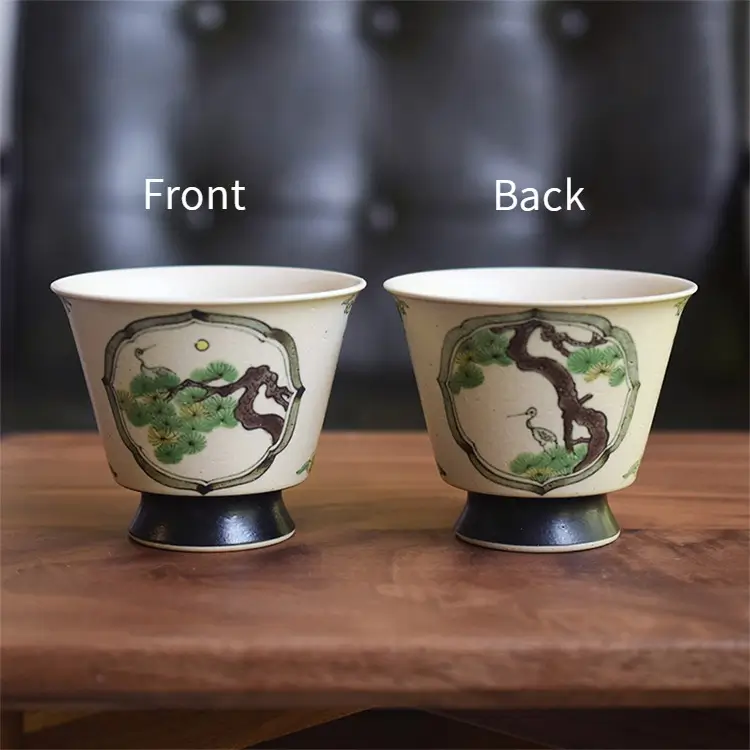 Handmade ceramic cup with underglaze pine and crane design, showcasing front and back view for modern tableware.