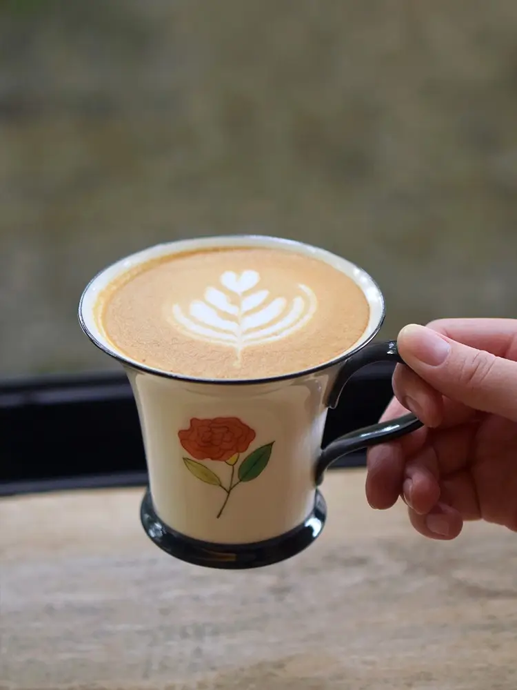Handmade ceramic mug features hand-painted roses, making it a heartfelt holiday gift for your wife.