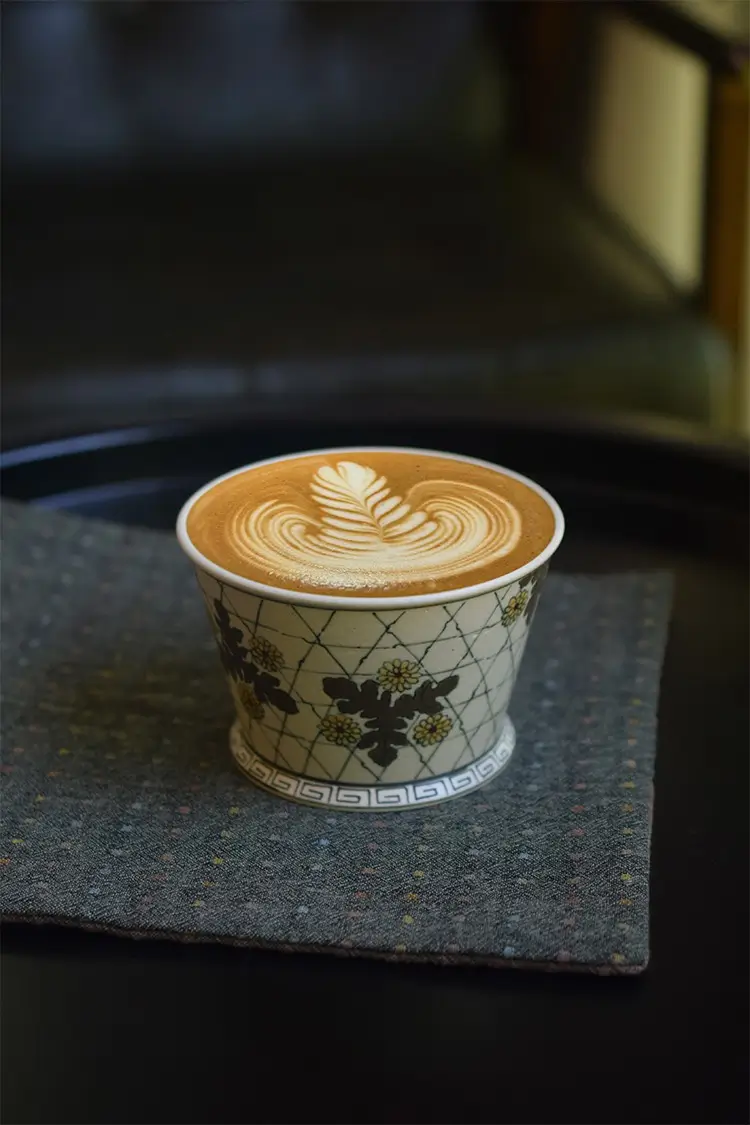 Handmade ceramic coffee mug showcases vintage underglaze chrysanthemum design, making it a charming addition to your decor.