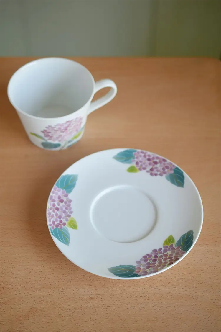 Handmade ceramic cup paired with matching hydrangea saucer, ideal for elegant kitchen dining.