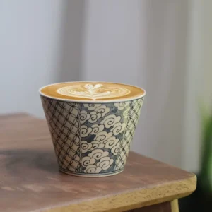 Handmade custom coffee cup with hand-painted blue cloud motif for elegant business use.