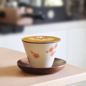 Handcrafted underglaze daisy coffee mug brings charm to daily rituals, making it ideal for teachers and flower lovers.