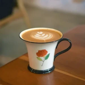 Handmade porcelain coffee mug featuring an underglaze rose design, perfect for lattes and goddess-inspired elegance.