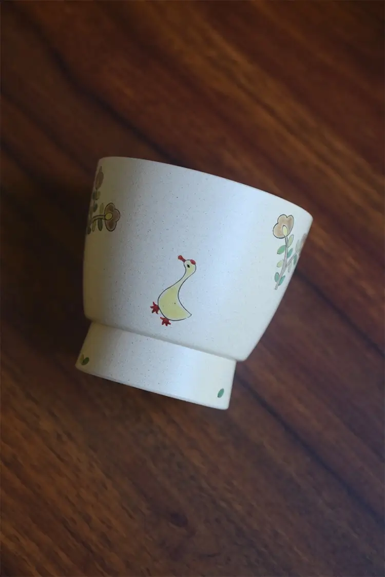 Handmade pottery mug with underglaze goose design, perfect for nature-inspired lifestyles.