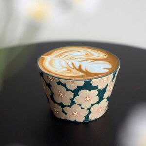 Hand-painted cherry blossom ceramic mug with latte, ideal for office business use