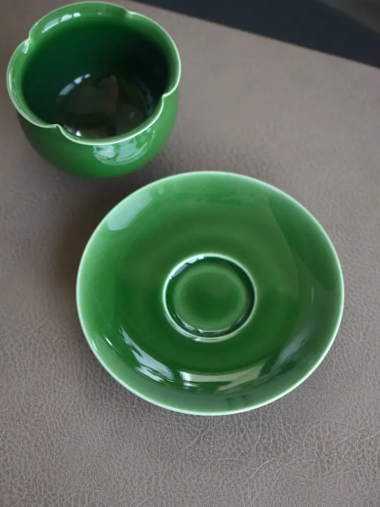 Enjoy a handmade jade green ceramic cup and saucer set that brings nature to your table.