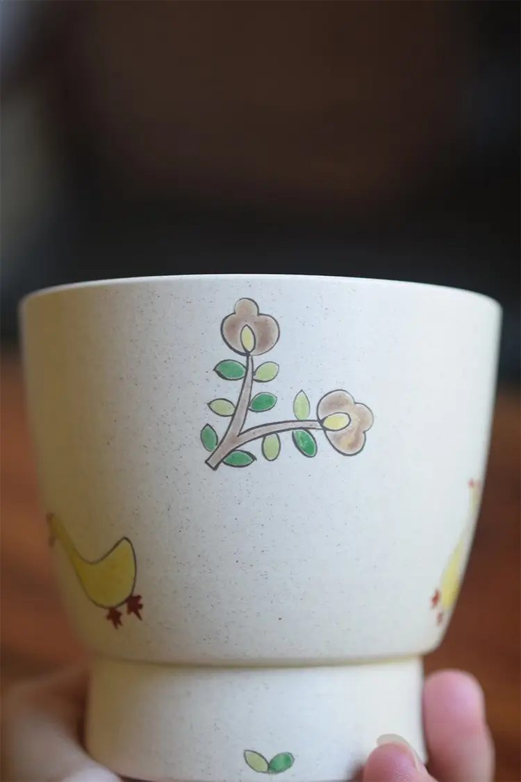 Nature-inspired ceramic tea cup with hand-painted floral design, made for tea lovers.