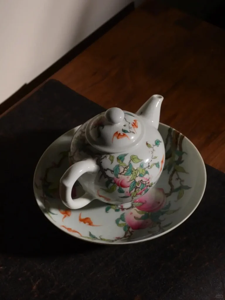 Rare peach-blossom glazed teapot with longevity symbolism, showcasing Xiaogu Tang's mineral pigment mastery