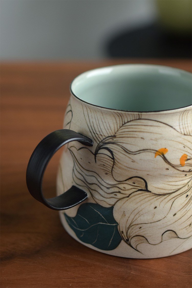 Nordic style ceramic mug with black handle, offering ergonomic grip and elegant coffee experience.