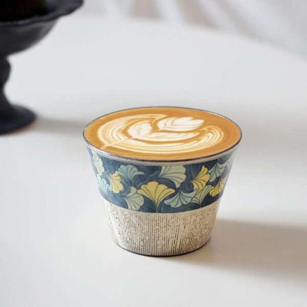 Handmade Japanese ceramic mug with hand-painted Ginkgo leaf design, perfect for brewing lattes.