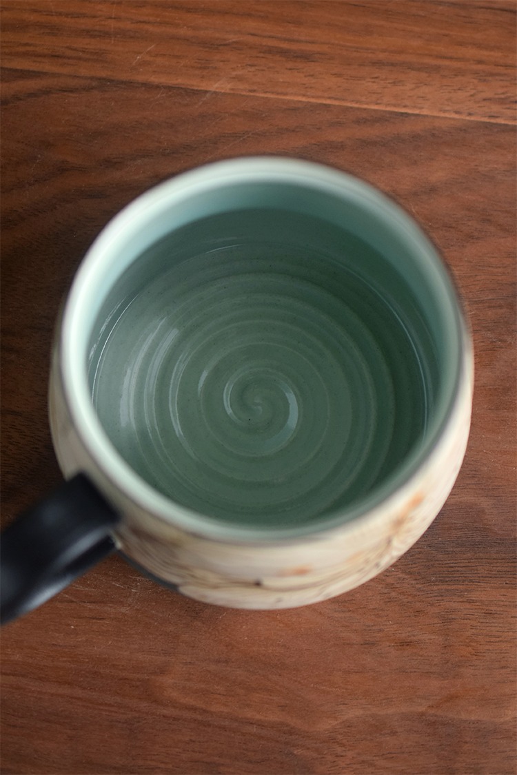 Interior detail of celadon-glazed ceramic cup with visible hand-thrown lines, ideal for handmade cup lovers.