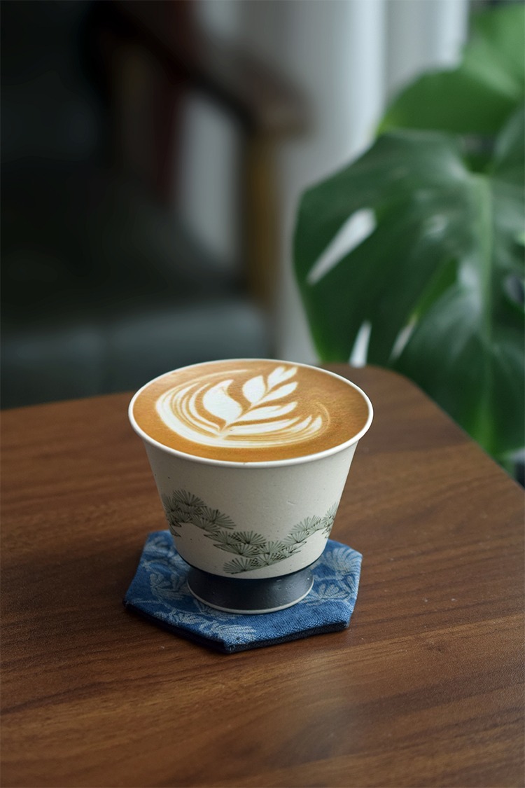 Hand-painted pine tree ceramic coffee cup, ideal for handmade brews at home or office.
