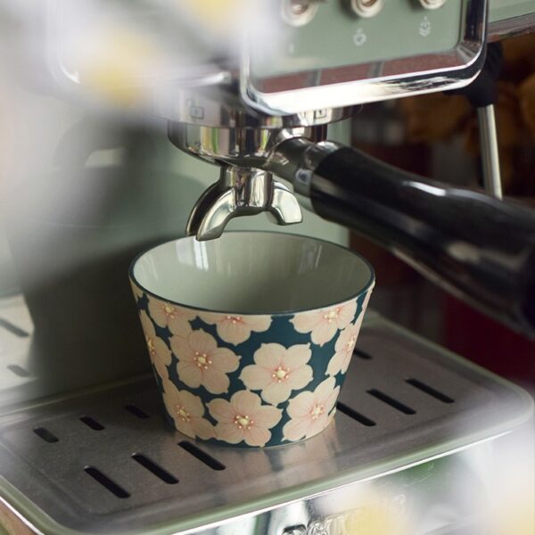 Handcrafted cherry blossom ceramic coffee cup, compatible with coffee machines, elegant and practical design.