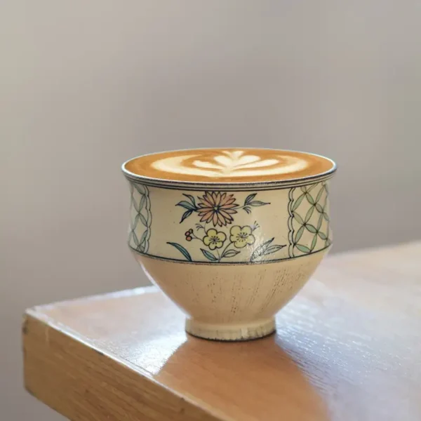 Place a vintage-style ceramic latte cup in a rustic home setting to enhance retro aesthetics with handmade charm
