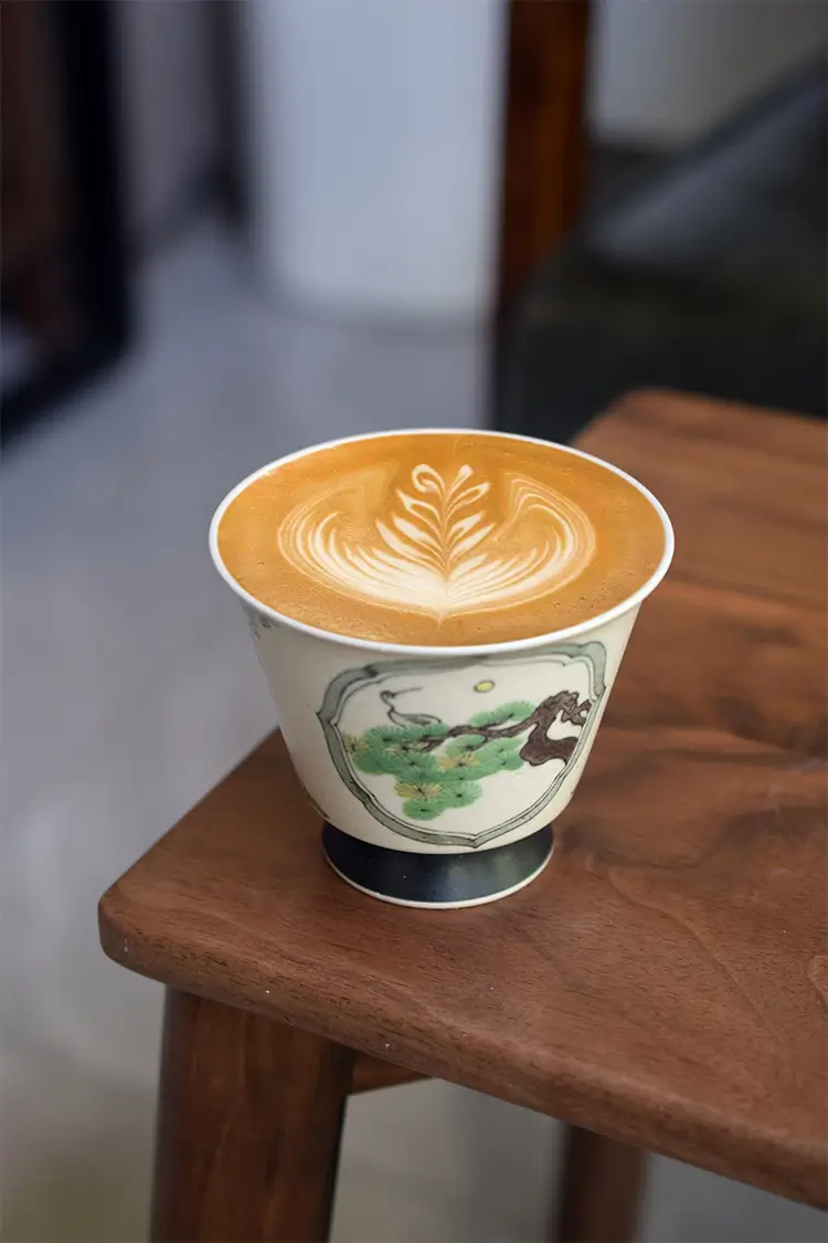 Vintage coffee mug showcases underglaze pine and crane design to elevate modern home dining taste.