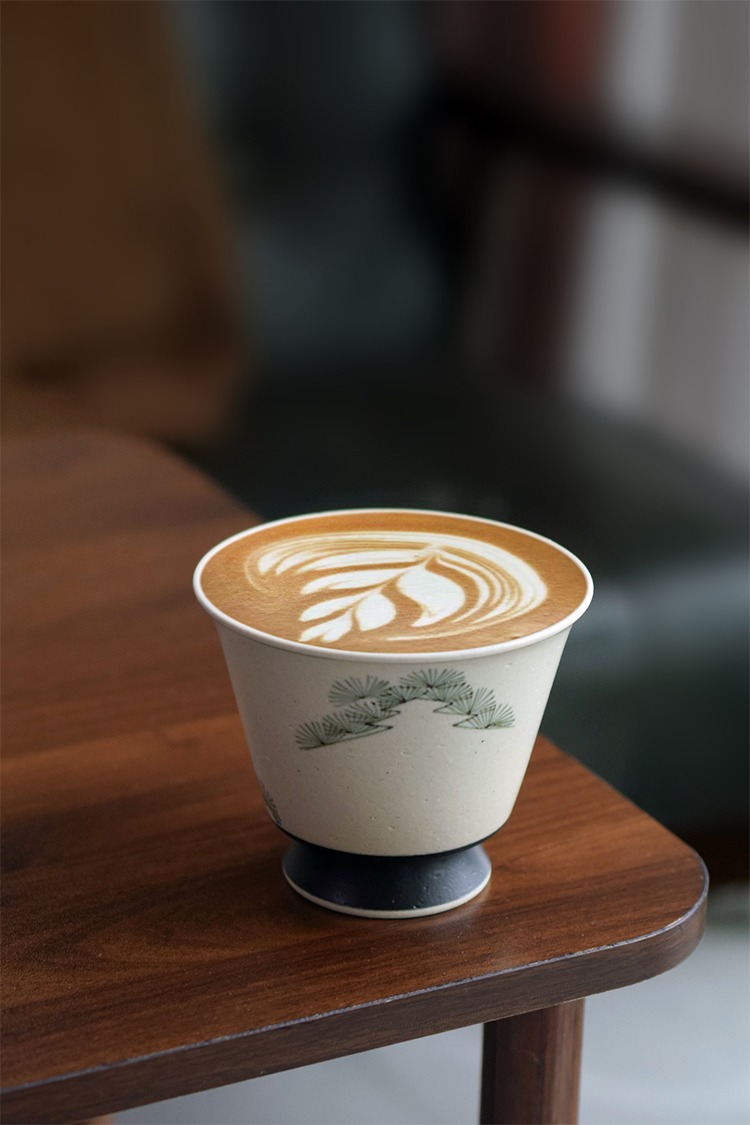 Vintage-style handmade ceramic coffee cup on table corner, ideal holiday gift for parents