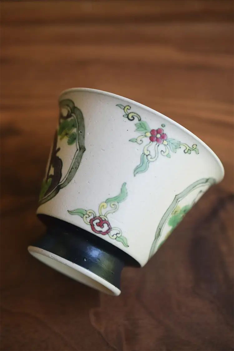 Vintage porcelain tea cup with underglaze painting, showcasing fine handcrafted ceramic detail and traditional charm.