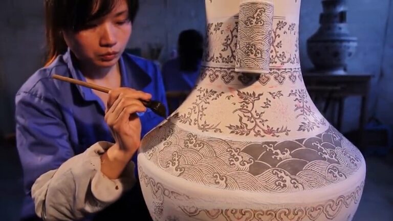 Female ceramic artist mixing water-based pigments by hand in a studio