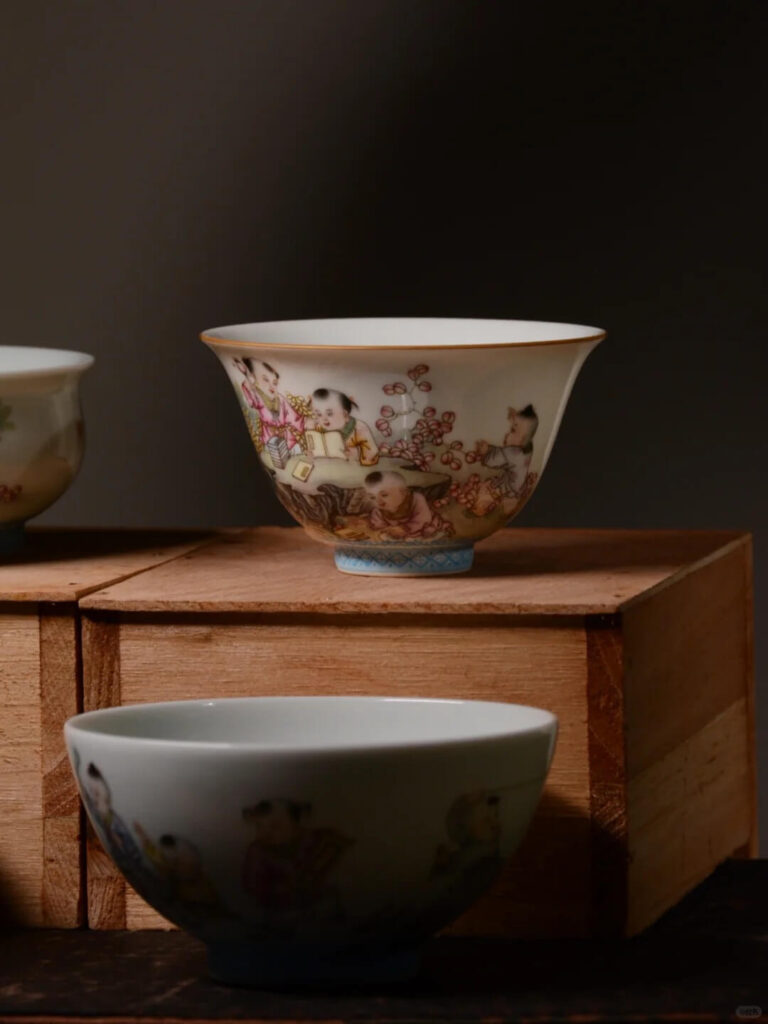 Close-up of matching tea cup and saucer set featuring intricate blue-and-white brushwork by Xiaogu Tang studio artists