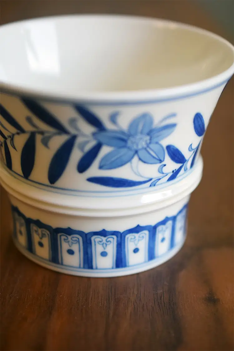 Blue and white ceramic coffee cup reveals smooth glaze surface with refined underglaze craftsmanship and elegant Chinese aesthetics.